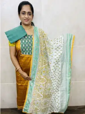 Cotton top with a patchwork on yoke paired with a block printed soft silk dupatta and cotton bottom